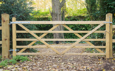 5 Bar wooden gate in a fence leading to a path