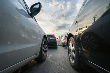 Fototapeta premium Cars on city street in traffic jam at rush hour