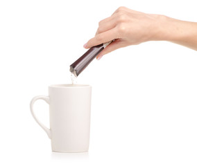 Instant coffee cappuccino in a stick in hand a  coffee cup mug on a white background. Isolation