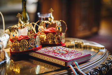 Fototapeta na wymiar Crowns for a orthodox wedding ceremony and a religious book