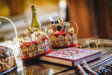 Fototapeta na wymiar Crowns for a orthodox wedding ceremony and a religious book
