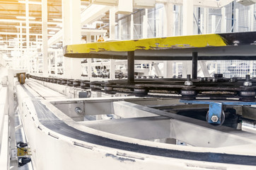 Large conveyor belt on a metal chain at a manufacturing plant