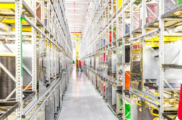 Large racks with coils of colored wires in an industrial plant. Wiring for cars - obrazy, fototapety, plakaty