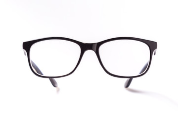 Fototapeta premium Black eye glasses spectacles with shiny black frame For reading daily life To a person with visual impairment isolaged on white background.