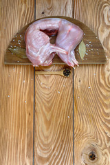 In the frame set for cooking rabbit with spices. A raw rabbit is put on a wooden board. Top view, free space for text. vetrykal image