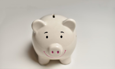 Finance, saving money, white piggy bank on seamless white background.