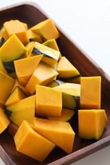 Chopped pumpkin on wooden plate