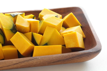 Chopped pumpkin on wooden plate