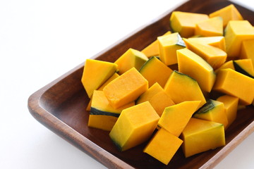 Chopped pumpkin on wooden plate