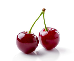 two cherry berries with branch close-up on white background

