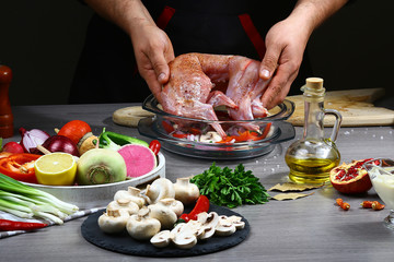 Cooking rabbit meat baked with vegetables by chef hands, steps process on kitchen on black background copy text recipe