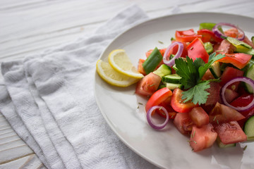 fresh salad with tomatoes and goat cheese. salat on white background