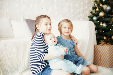 Three sisters   sitting on   floor near   New Year