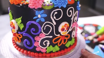Step by step. Baker decorating multilayer chocolate cake with colorful italian buttercream frosting. - Powered by Adobe