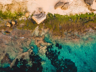 Turquoise ocean water with beach, aerial drone shot. Top view