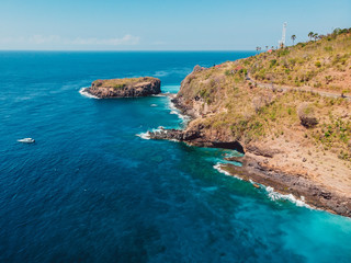 Blue ocean with rocky coast and island. Aerial view.