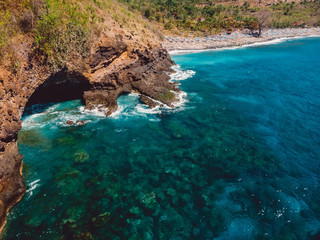 Blue ocean with rocky coast and beach. Aerial view.