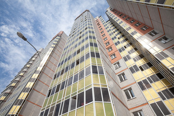 Fototapeta premium bottom view of the facade of a new high-rise building in the new area