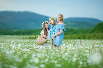Happy mother and daughter child together with yellow dandelion flowers in summer day enjoy vacation free time together happy