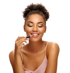 Beautiful girl applying lipstick on her lips. Photo of african american girl with perfect makeup on...