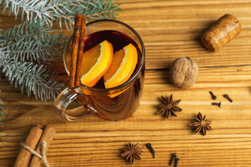 Autumn and winter seasonal mulled wine on a wooden table with spices