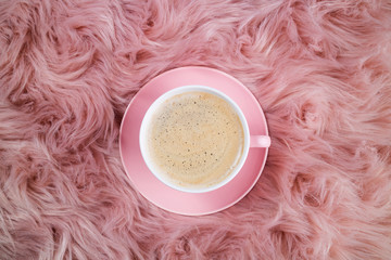 Coffee cup on pink woolen fur. Femininity trendy composition. Breakfast, domestic life, weekend,...