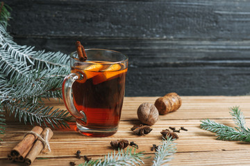 Autumn and winter seasonal mulled wine on a wooden table with spices