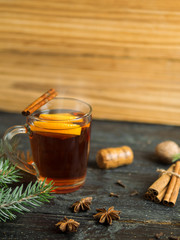 Hot winter drink mulled wine on dark wooden table