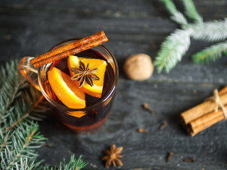 Hot winter drink mulled wine on dark wooden table