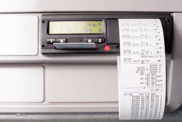 Digital tachograph with printed time records and driver card half inserted