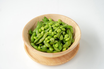 Green soybeans on a wooden bowl