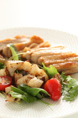 stir fried lotus root served baby leaves and grilled chicken wings