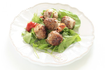 homemade meat ball served with baby leaves and ketchup