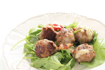 homemade meat ball served with baby leaves and ketchup