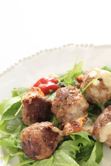 homemade meat ball served with baby leaves and ketchup