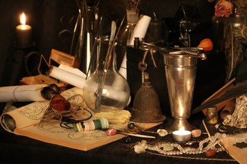 Antique Magic Book. Witchcraft Peacock feathers and candle background. Black candle Magic Ritual.