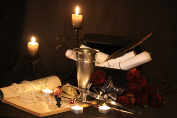 Antique Magic Book. Witchcraft Peacock feathers and candle background. Black candle Magic Ritual.