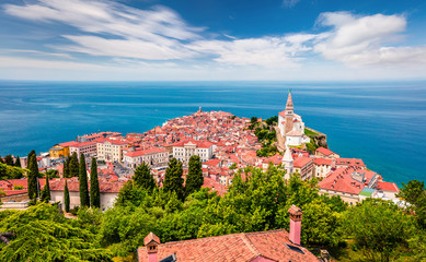 Aerial view of old town Piran. Colorful spring morning on Adriatic Sea. Beautiful cityscape of Slovenia, Europe. Traveling concept background. Magnificent Mediterranean landscape.
