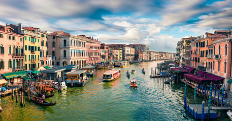 Fototapeta na wymiar Great scene of famous Canal Grande. Colorful spring view from Rialto Bridge of Venice, Italy, Europe. Picturesque morning seascape of Adriatic Sea. Traveling concept background.