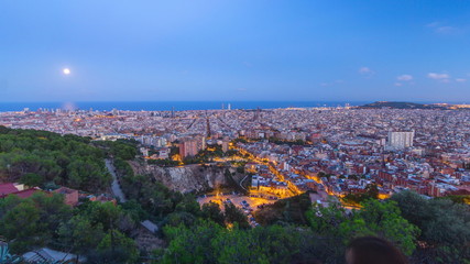 View of Barcelona day to night timelapse, the Mediterranean sea, The tower Agbar and The twin towers from Bunkers Carmel. Catalonia, Spain.