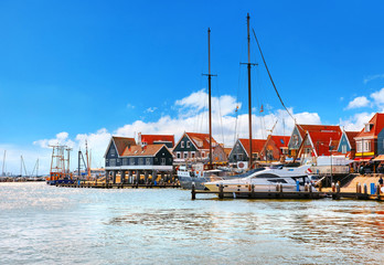 Fototapeta na wymiar Volendam, Netherlands. High-speed motorboat by docks near old