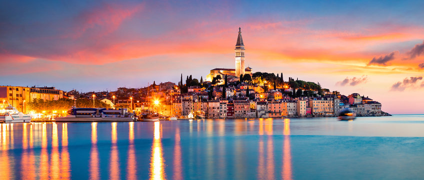 Fantastic spring sunset of Rovinj town, Croatian fishing port on the west coast of the Istrian peninsula. Colorful evening seascape of Adriatic Sea. Traveling concept background.