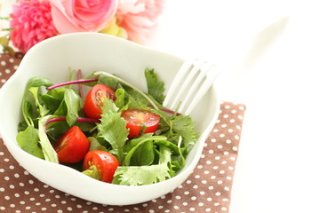 Homemade cherry tomato and baby leaves salad for healthy eating image