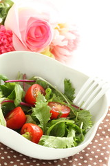 Homemade cherry tomato and baby leaves salad for healthy eating image
