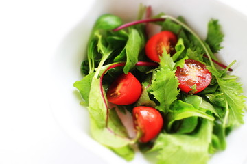 Homemade cherry tomato and baby leaves salad for healthy eating image