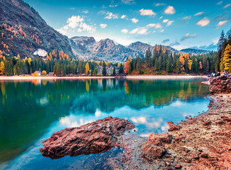 Beautiful morning on Braies Lake. Colorful autumn landscape of Italian Alps, Naturpark Fanes-Sennes-Prags, Dolomite, Italy, Europe. Traveling concept background.