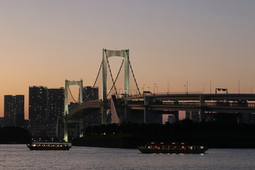 Fototapeta na wymiar View from Odaiba Beach to Tokyo Bay with Rainbow Bridge at dusk, Tokyo, Japan