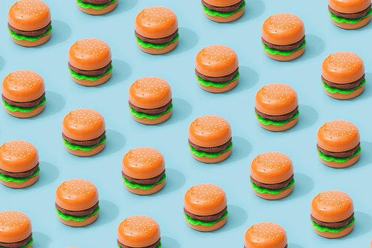 Hamburger fast food pattern on pastel blue background. Minimal junk food concept.