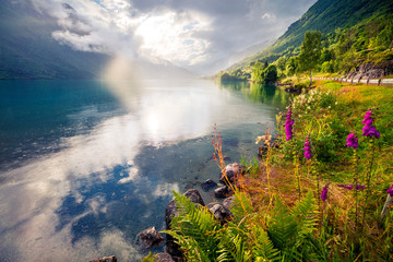 Dramatic summer view of Lovatnet lake, municipality of Stryn, Sogn og Fjordane county, Norway. Colorful rainy scene in Norway. Beauty of nature concept background.