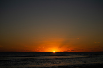 Obraz premium Sunset at the beach with orange colors